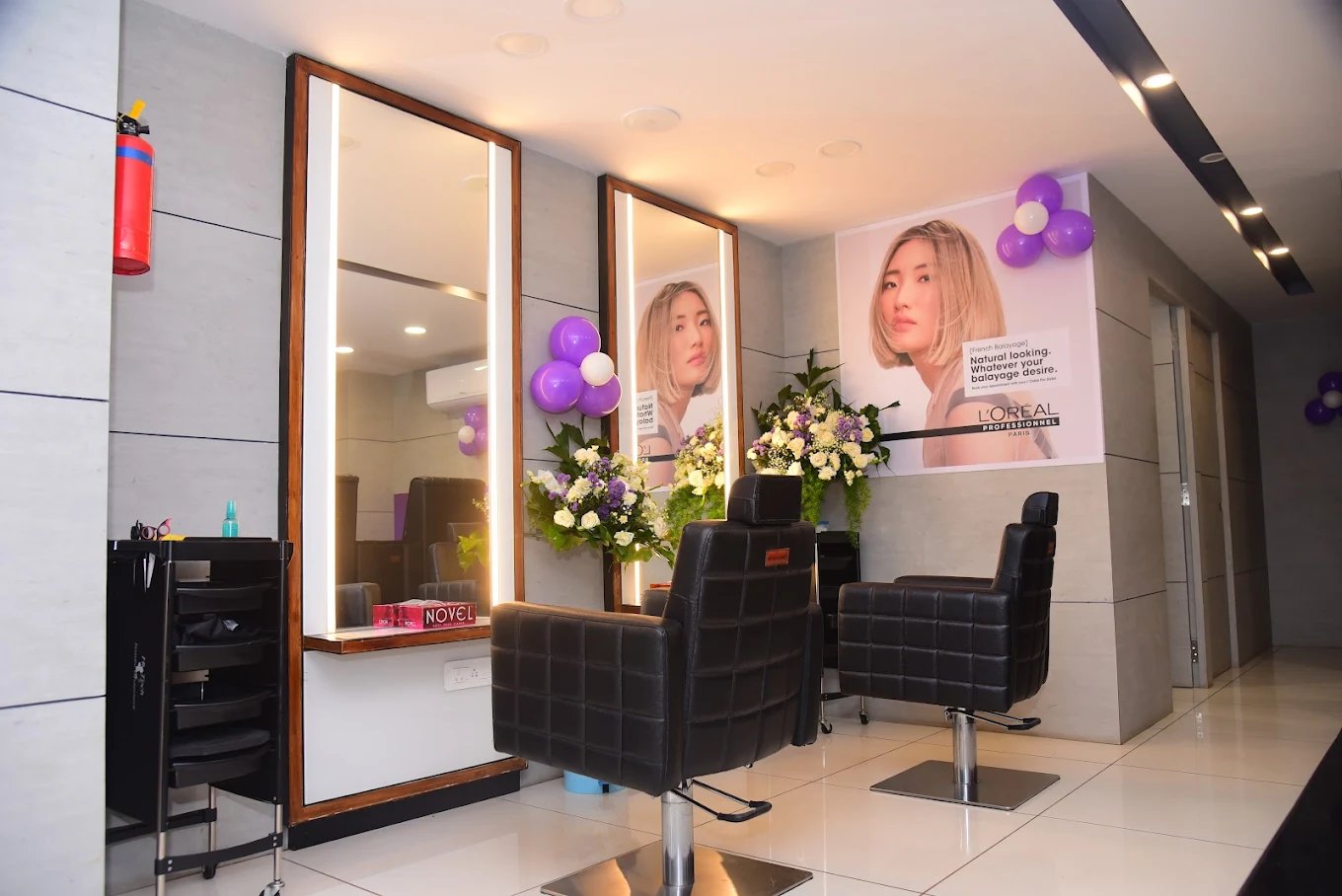 Interior of Royal Look styling stations with lit mirrors and premium chairs